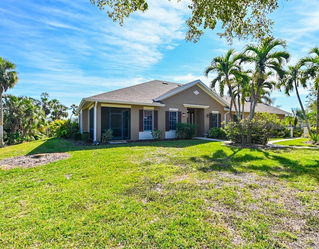 single story home featuring a front lawn