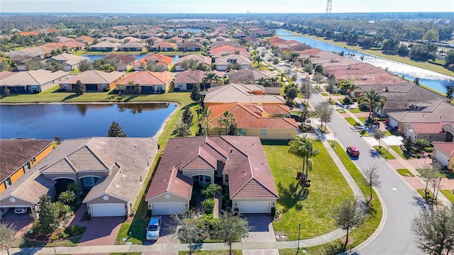 birds eye view of property with a water view