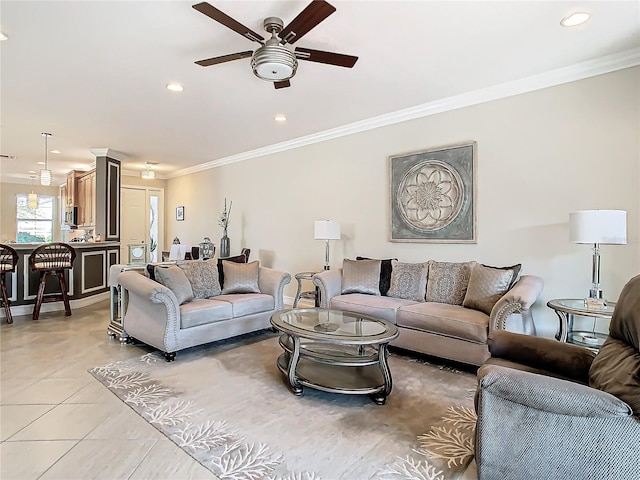 tiled living room featuring ornamental molding and ceiling fan