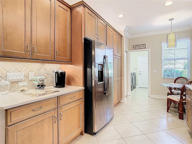 kitchen featuring ornamental molding, pendant lighting, stainless steel fridge, and decorative backsplash