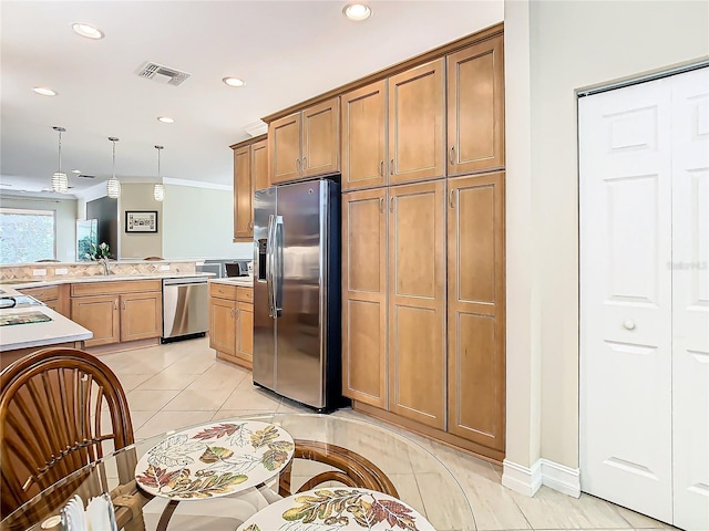 kitchen with stainless steel appliances, hanging light fixtures, sink, and light tile patterned floors