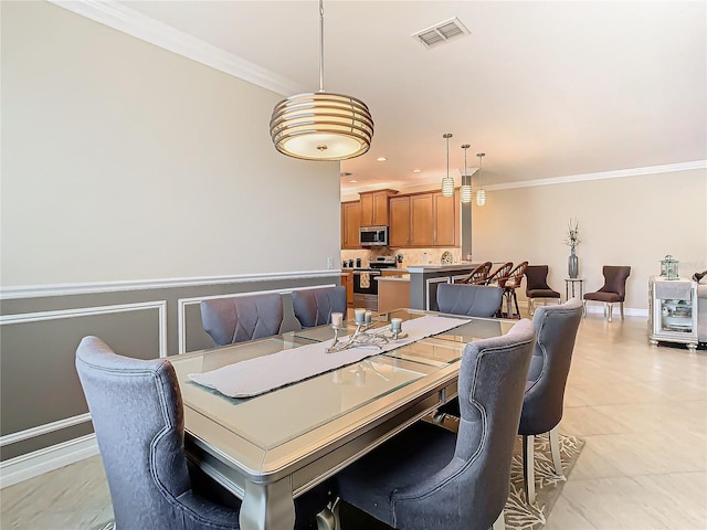 dining area featuring light tile patterned floors and ornamental molding