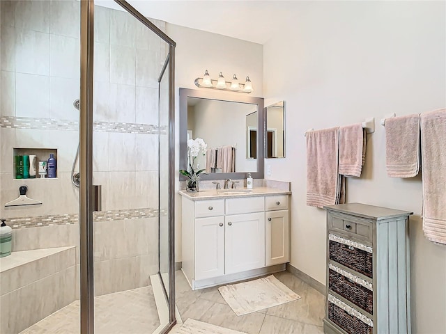 bathroom with vanity and a shower with shower door