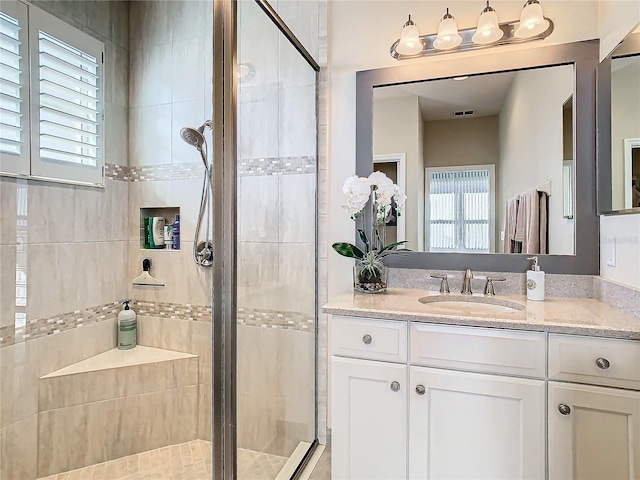 bathroom with vanity and an enclosed shower