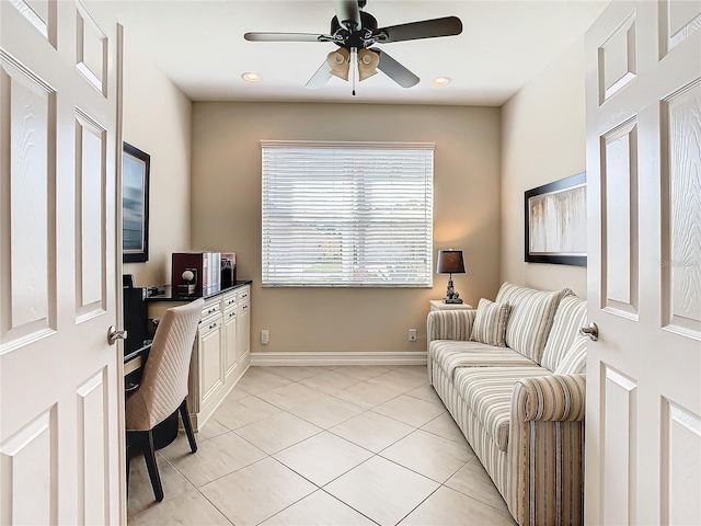 tiled home office featuring ceiling fan