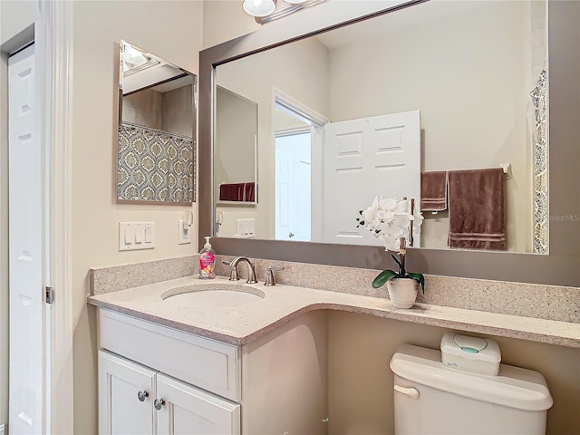 bathroom featuring vanity, toilet, and a shower with shower curtain