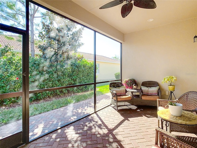 sunroom featuring ceiling fan