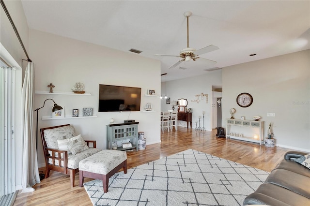 living room featuring hardwood / wood-style flooring and ceiling fan