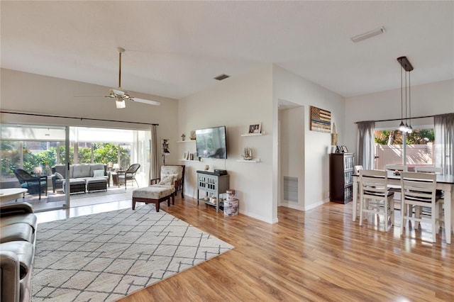 living room with light hardwood / wood-style flooring and ceiling fan