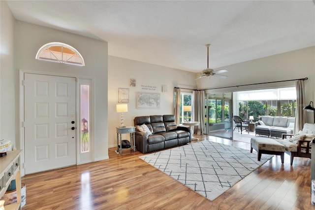 living room with light hardwood / wood-style flooring and ceiling fan