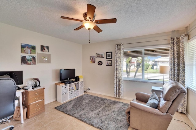 tiled office with a textured ceiling and ceiling fan