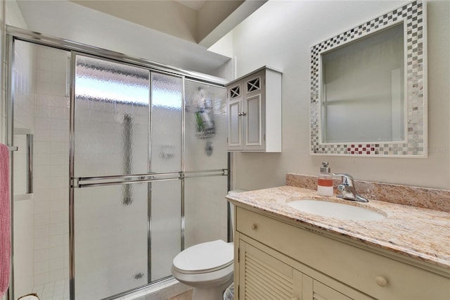 bathroom with walk in shower, vanity, and toilet