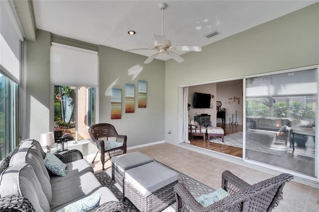 living room with light tile patterned flooring and ceiling fan