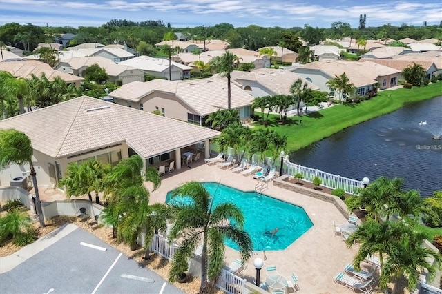 view of swimming pool with a water view and a patio area