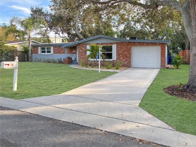 single story home featuring a garage and a front lawn