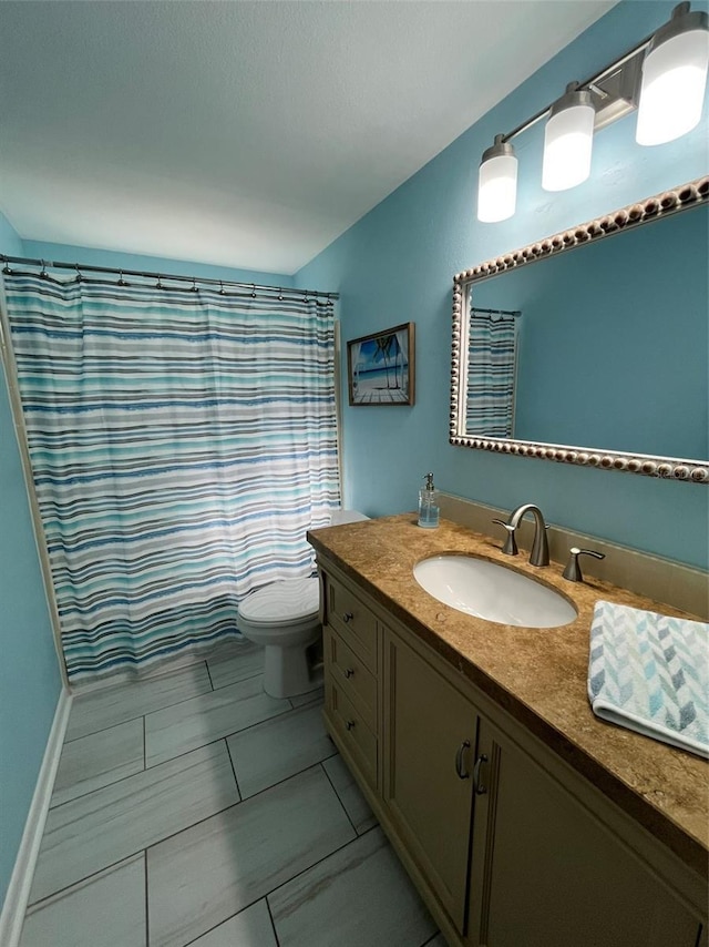 bathroom with a shower with curtain, vanity, and toilet