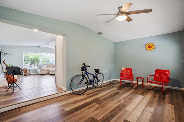 sitting room with lofted ceiling with beams, hardwood / wood-style floors, and ceiling fan