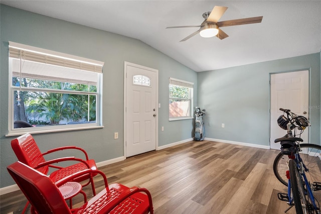 interior space featuring ceiling fan, lofted ceiling, and light wood-type flooring