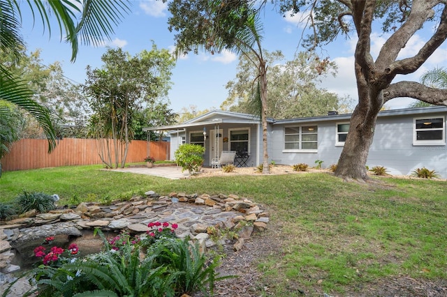 view of front of property with a front lawn and a patio