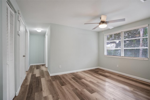 spare room featuring wood-type flooring and ceiling fan