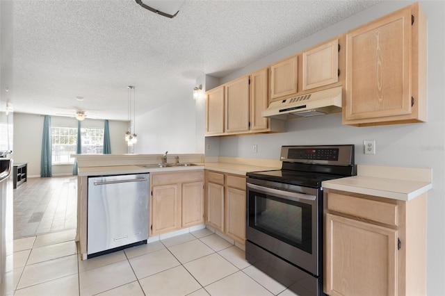 kitchen featuring light brown cabinetry, sink, appliances with stainless steel finishes, kitchen peninsula, and pendant lighting