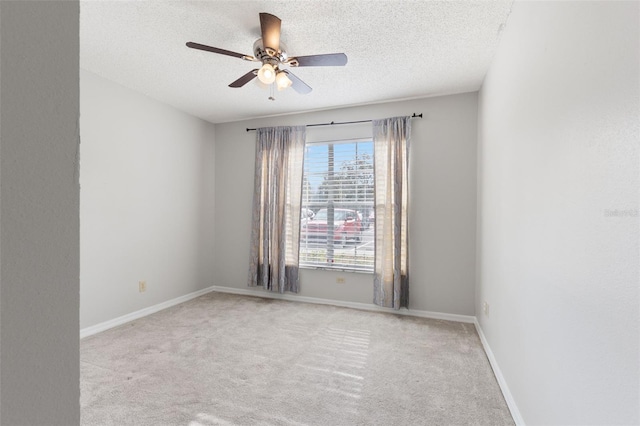 unfurnished room featuring ceiling fan, light carpet, and a textured ceiling