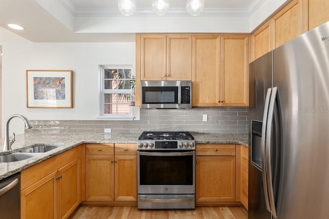 kitchen with sink, backsplash, ornamental molding, light stone counters, and stainless steel appliances