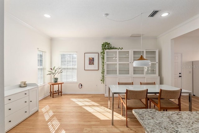 living area with crown molding and light hardwood / wood-style floors