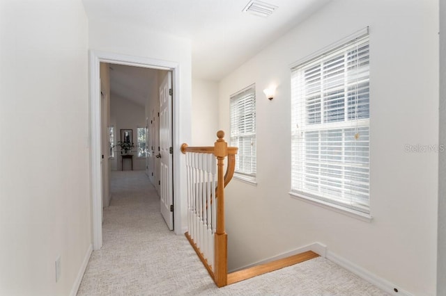 hallway with light colored carpet