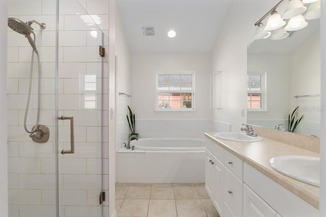 bathroom featuring tile patterned floors, shower with separate bathtub, and vanity