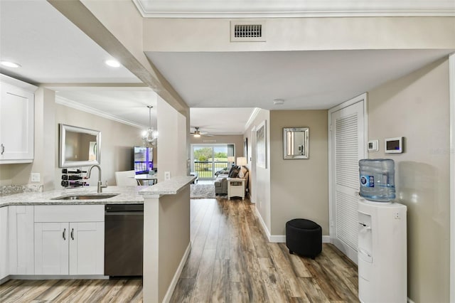 kitchen featuring sink, ornamental molding, dishwasher, light hardwood / wood-style floors, and white cabinets