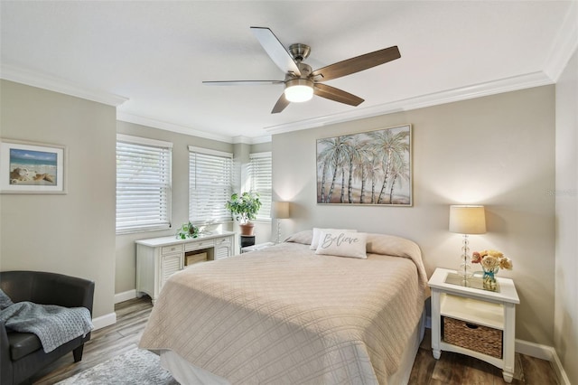 bedroom featuring hardwood / wood-style flooring, ceiling fan, and crown molding