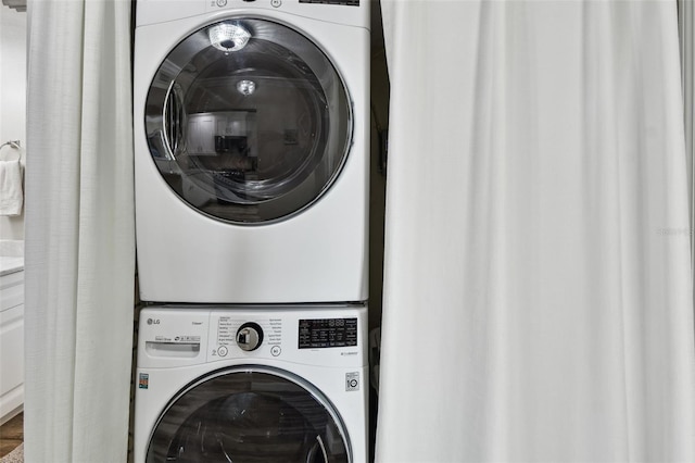 washroom featuring stacked washer and dryer