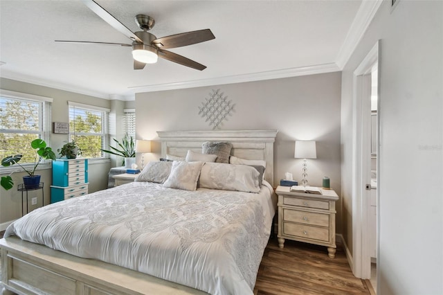 bedroom with ornamental molding, dark hardwood / wood-style floors, and ceiling fan