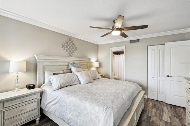 bedroom featuring ornamental molding, dark hardwood / wood-style floors, ensuite bathroom, and a closet