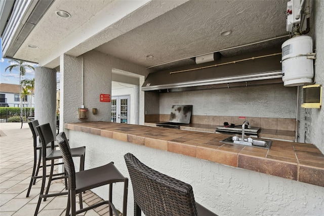 kitchen with sink and a wall of windows