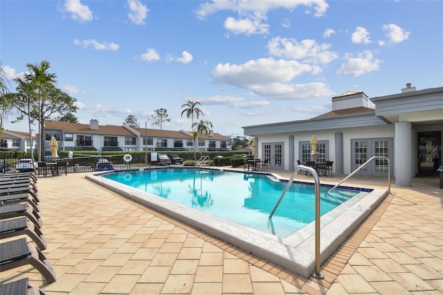 view of pool featuring a patio area and french doors