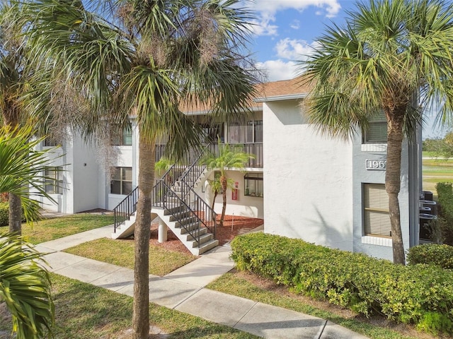 view of property featuring stairs