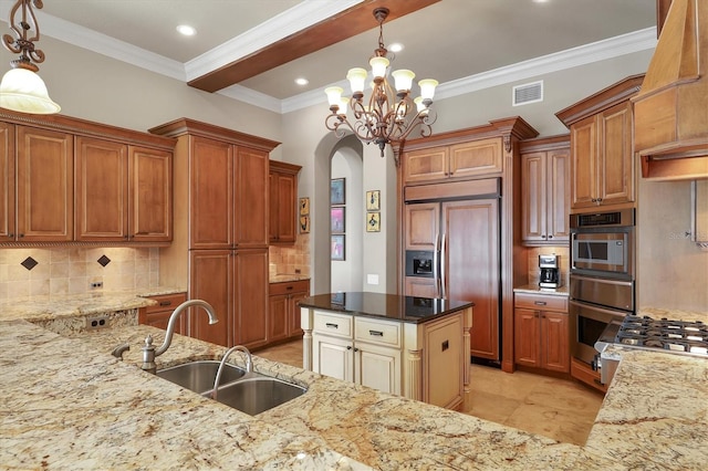 kitchen featuring pendant lighting, sink, paneled built in fridge, and dark stone countertops