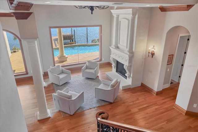 living room with ornate columns and light hardwood / wood-style floors