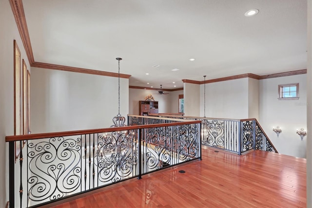 hallway with hardwood / wood-style flooring and crown molding