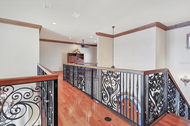 hallway with hardwood / wood-style flooring and ornamental molding