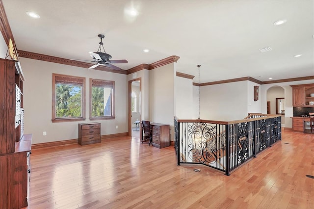 interior space with crown molding, ceiling fan, and light hardwood / wood-style flooring