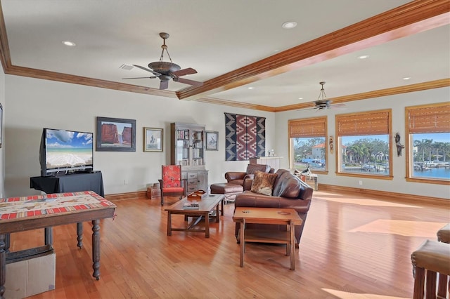 living room featuring ceiling fan, ornamental molding, and light hardwood / wood-style floors