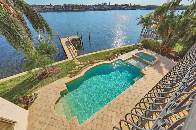 view of swimming pool featuring a dock, an in ground hot tub, and a water view