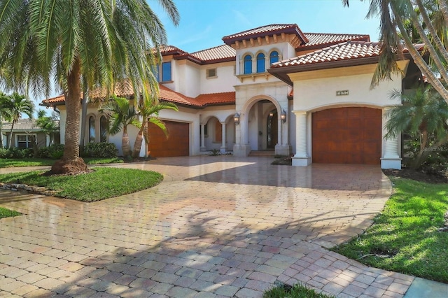 mediterranean / spanish-style home with a garage