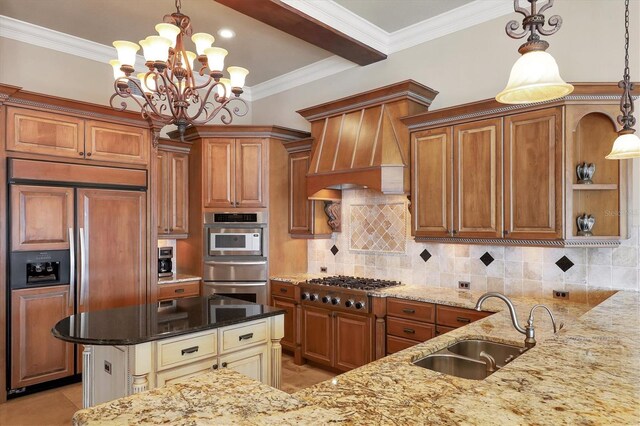 kitchen with dark stone countertops, hanging light fixtures, stainless steel appliances, and sink