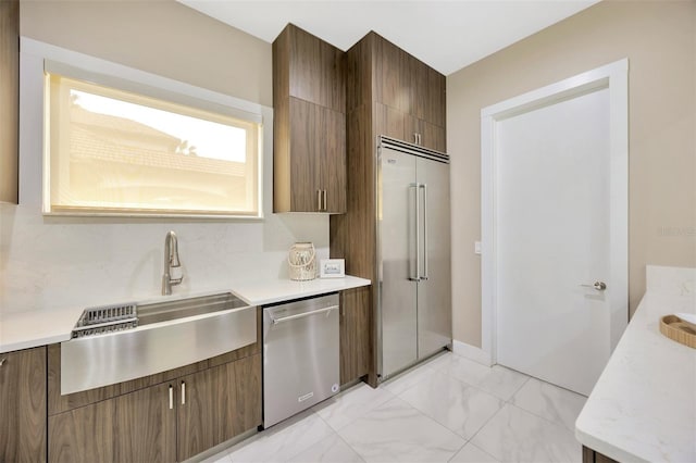 kitchen featuring sink, backsplash, and appliances with stainless steel finishes