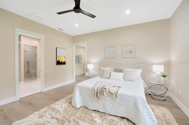 bedroom with ensuite bathroom, ceiling fan, and light hardwood / wood-style floors