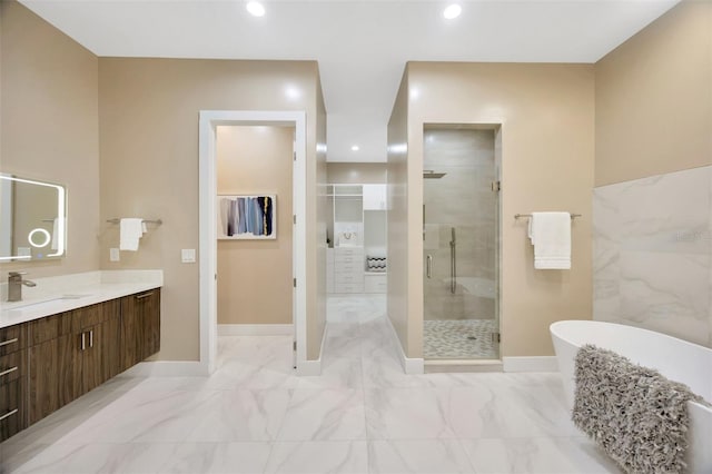 bathroom with vanity and separate shower and tub